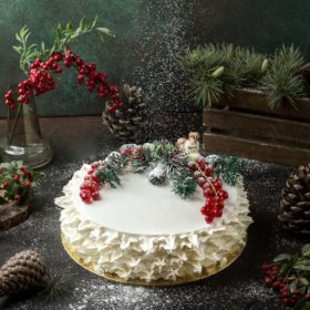 cream cake with cranberries on the table